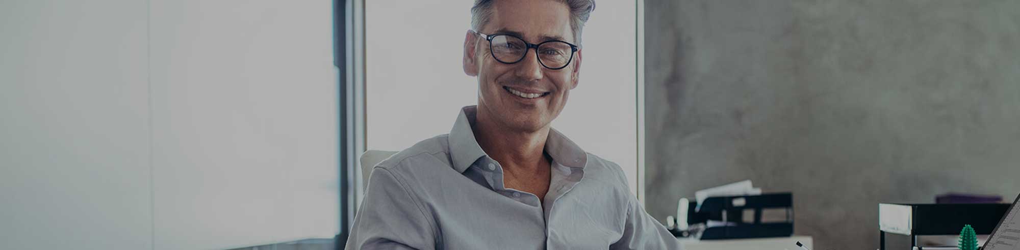 middle-aged man with glasses looking at the camera